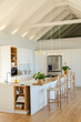 © Wavebreak Media - Central kitchen island showing wood countertop under dome pendant lights with open shelves