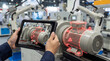 © AiDesign - Industrial technician using augmented reality tablet for predictive maintenance diagnostics on electric motor showing bearing wear alerts