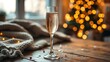 © qinglan - dcf. A champagne flute with golden bubbles on a wooden table beside a cozy blanket and festive confetti. bar promotions, beverage menus, designed for food & beverage menus and cafe branding.
