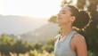 © alinea - Peaceful woman practicing mindfulness outdoors at sunrise, breathing deeply in nature, symbolizing wellness, relaxation, mental balance, and a healthy active lifestyle.