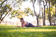 © Pichsakul - Young Asian woman performing outdoor yoga stretch in sunny park practicing healthy wellness fitness lifestyle mindful movement exercise