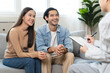 © Pormezz - Psychology, depression asian young couple, patient consulting problem mental health with psychologist, psychiatrist at clinic together, husband encouraging by holding hand of wife, therapy health care
