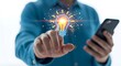 © Pranto - Businessman touching glowing digital lightbulb icon while holding a smartphone symbolizing mobile innovation and new ideas
