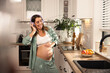 © milanmarkovic78 - Pregnant Woman Enjoying Music And Dancing In The Kitchen