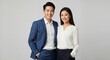 © Vasiliy - Portrait of a happy Asian business couple standing together. Young professional man and woman smiling in studio. Corporate teamwork concept
