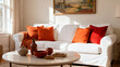 © duyina1990 - A bright and cozy living room featuring a white sofa adorned with colorful orange and red pillows, a round coffee table, and warm natural light.