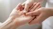 © Anna - Two hands performing acupuncture therapy in wellness clinic. Close-up of a hand receiving a soothing massage, highlighting fingers and palm relaxation.