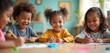 © Pete - Group of diverse kids sitting at table, drawing with colored pencils, smiling. Children engaged in art activity together in classroom. Happy kids doing arts and crafts at day care center.