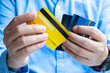 © Media  - Woman holding credit cards and he is choosing a credit card to pay and spend Payment for goods via credit card. Finance and banking concept