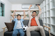 © itchaznong - Father and son celebrating a sports victory at home