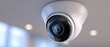 © Studio Nova - The security camera mounted on the ceiling in a modern office with blurred background