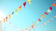 © Heru - Festive Colorful Triangular Bunting Flags Hanging Against a Clear Bright Blue Summer Sky Background