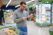 © Serhii - Shocked man looking at fiscal receipt in grocery store