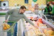 © Serhii - Handsome man shopping in a supermarket