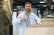 © Serhii - Customer showing thumb up while choosing ceramic tiles in hardware store