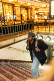 Young black man ascending subway stairs in paris at night