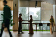 © BusinessClass by W61 - Colleagues having a discussion in a modern office interior