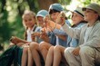 © standret - Making the knot on the rope, sitting. Group of children in the forest on a hike