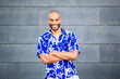 © Paula - Confident man standing with arms crossed and smiling in blue floral shirt