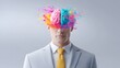 © pkproject - Conceptual image of a businessman with a pink and teal brain bursting with vibrant powder representing innovation logic and ic expression