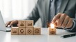 © Fatimah - Businessman lighting wooden blocks with success icons on a desk
