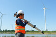 © YaMo - Engineers are using a camera to survey the distance of road construction in a wind farm.