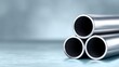 © Nataliia_Trushchenko - Three metallic pipes arranged in a triangular formation, showcasing smooth surfaces and reflective qualities, set against a soft blurred background emphasizing industrial design and craftsmanship