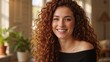 © Vasiliy - Happy young woman with long curly red hair smiling. Close-up portrait of a cheerful female with a radiant smile. Natural beauty and confidence concept