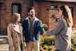 © Maria Vitkovska - Happy smiling couple shaking hands with realtor after buying new home