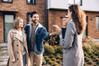 © Maria Vitkovska - Happy couple receiving new house keys from real estate agent