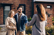 © Maria Vitkovska - Smiling successful woman and man shaking hands with realtor buying property on the street outdoors