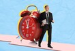 © Pixel-Shot - Businessman and big alarm clock on blue background. Time management concept