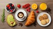 © Von - A breakfast table with a croissant, coffee, and fresh fruit.