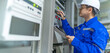 © reewungjunerr - Electrical engineer woman checking voltage at the Power Distribution Cabinet in the control room,preventive maintenance Yearly,Thailand Electrician working at company