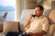 © Antonioguillem - Man drinking coffee alone at sunset at home