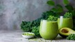© tashechka - Green smoothie made with kale and avocado on a kitchen counter in daylight