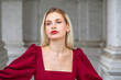 © Andrey_Arkusha - Portrait of a young beautiful blonde girl in an evening burgundy dress