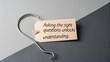 © Aifaa - Wooden tag with text asking right questions for better understanding