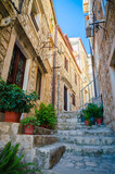 Famous narrow street and old city walls in Dubrovnik, Croatia