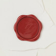 © inventive - Classic red wax seal on cream paper background for vintage correspondence and branding
