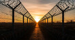 © Ranu - Sunset view through barbed wire fence