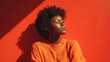 © Olena - Vibrant Red Portrait of a Young Afro Woman Embracing Nature in Daylight