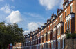 © Roksana Tomasiak - Central London real estate - a row of terraced houses against summer blue sky.
