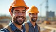 © Viktor - Two construction workers in hard hats smiling. Men at work on a building site. Teamwork pro portrait. The image shows positive attitude and safety in the workplace.