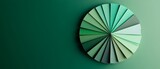 A minimalist design featuring a circular arrangement of geometric shapes in varying shades of green against a solid green background, ideal for modern graphics and design projects.