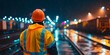 © Ytnart - A safety-conscious worker in a bright jacket watches over a bustling train yard at night, reflecting the importance of safety and vigilance in the transportation industry.