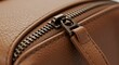 © Muhamat - Close-up of a Brown Leather Bag Zipper, Detailed Texture and Craftsmanship.