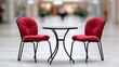 © Katsiaryna - Chairs and table arranged in a mall setting for customers to relax