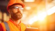 © tashechka - Worker with safety gear checks tablet in industrial setting during daylight