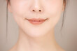 © kapinon - 髪の毛がアップ背景がベージュの使いやすい美容やスキンケアの美しい女性のリップライン(口元)のイメージクローズアップ　